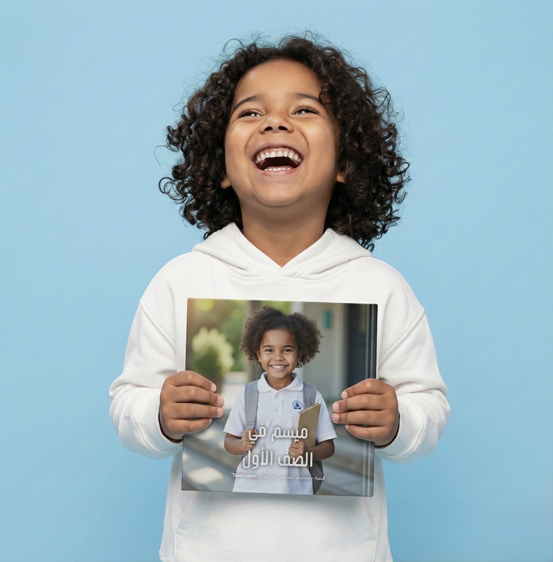 A child holding a Taletoons personalized story featuring himself